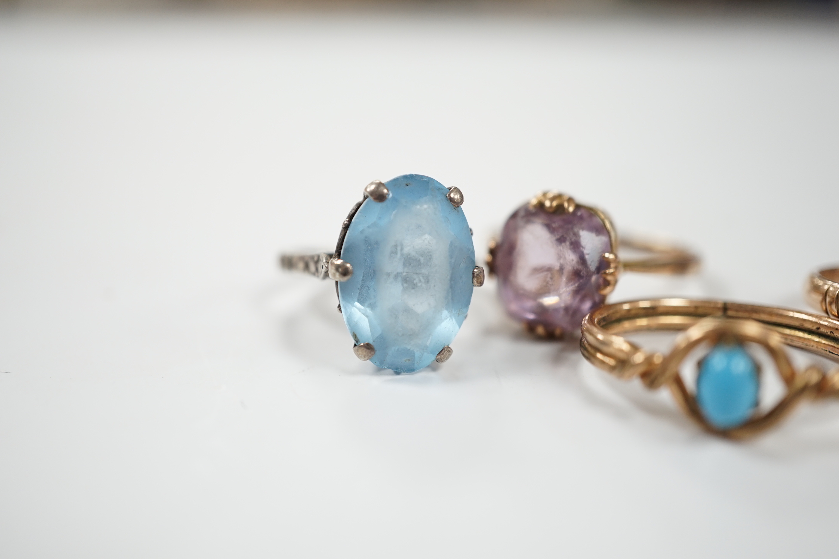 Two yellow metal and gem set rings, one stamped 9ct, gross weight 7.7 grams and two other rings.